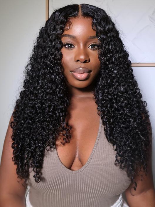 A model displays the UNice 20 Inch 6x4.5 Glueless Bye Bye Knots Pre-Cut Lace Wig Jerry Curly With, showing a model with long curly hair wearing a grey top and jerry curl.