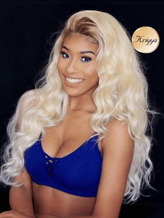A model displays the UNice Kriyya Full Lace Pre-Plucked Blonde Wig with Dark Roots, showing a blonde wig with long wavy hair and lace finish.