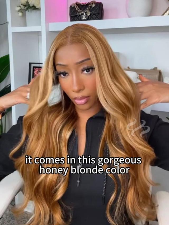 A model displays the UNice 7x5 Bye Bye Knots Wig Glueless Lace Honey Blonde Body Wave Drawstring Wig With, showing a model with long blonde hair and a black jacket.