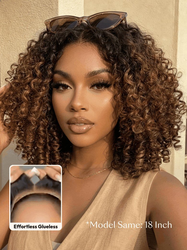 A smiling woman with long, voluminous, curly hair and subtle highlights wears a sleeveless knit top. An inset shows a close-up of her scalp with the realistic hairline of the brown highlight wig labeled “Invisiknots & Glueless.”.