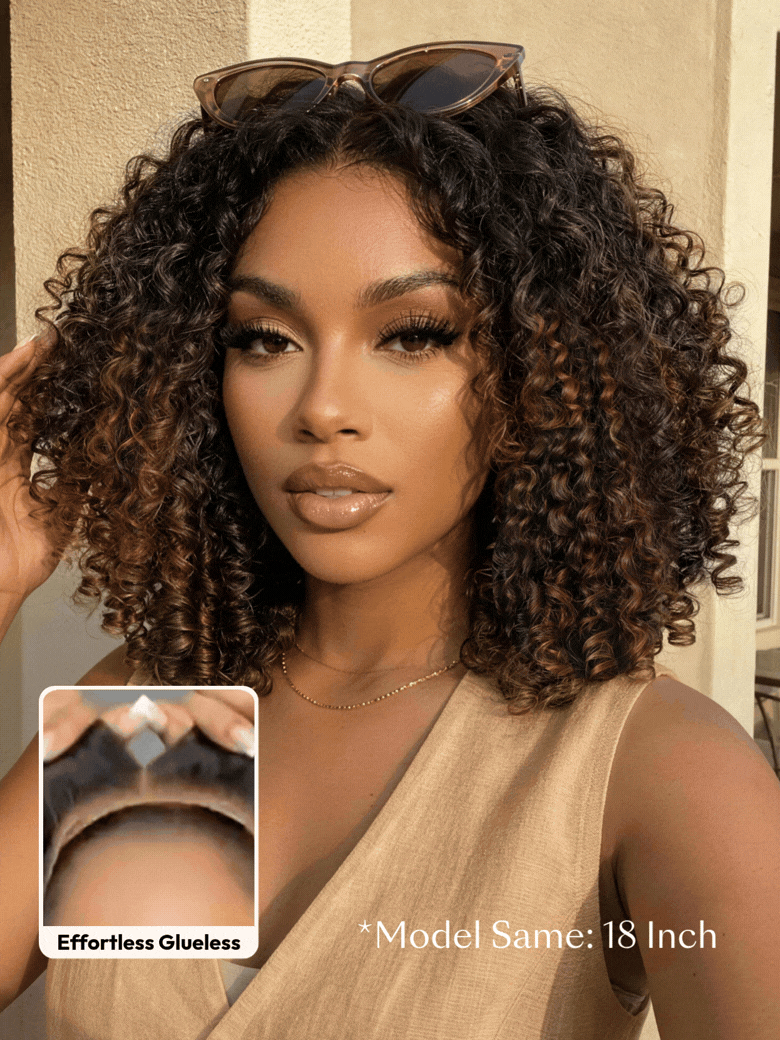 A smiling woman with long, voluminous, curly hair and subtle highlights wears a sleeveless knit top. An inset shows a close-up of her scalp with the realistic hairline of the brown highlight wig labeled “Invisiknots & Glueless.”.