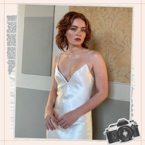 Sadie Sink short wavy copper red bob haircut in white dress