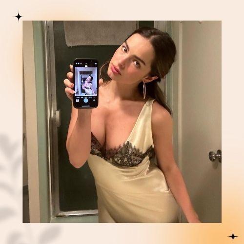 Addison Rae with natural brown hair taking a mirror selfie