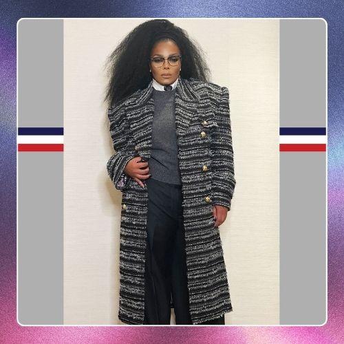 Janet Jackson wearing a long tweed coat with voluminous big hair