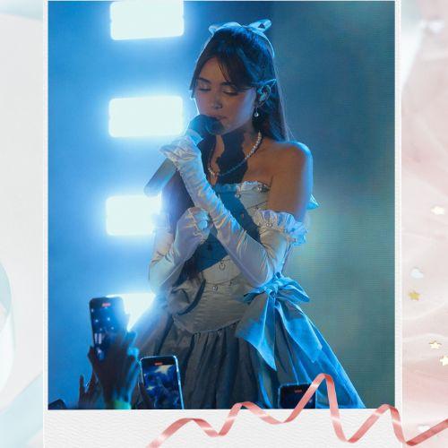 Madison Beer wearing long wavy hair with an oversized bow hairstyle