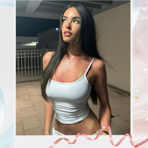 Madison Beer with sleek long black hair styled in straight