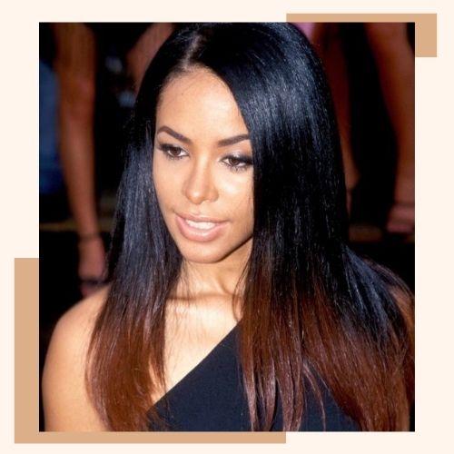 Aaliyah with long wavy blonde hair and dark roots side part