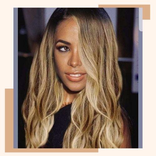 Aaliyah with long wavy blonde hair and dark roots side part
