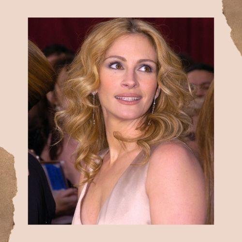 Julia Roberts in a pink dress showcasing smooth golden-brown wavy hair