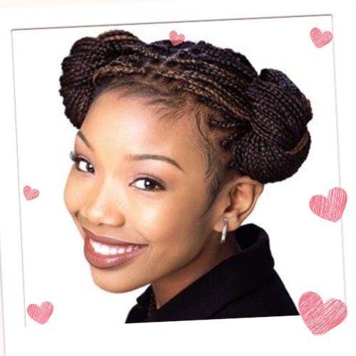 Brandy Norwood smiling with a double braided bun hairstyle made of thin individual box braids