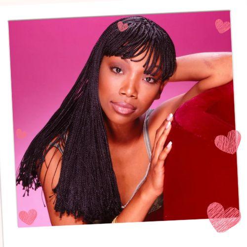 Brandy Norwood featuring waist-length micro braids paired with a full set of blunt braided bangs