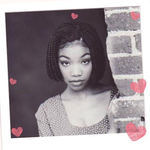 Black and white portrait of young Brandy Norwood wearing a neat chin-length braided bob hairstyle