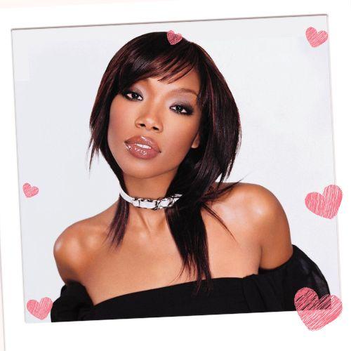Brandy Norwood with sleek layered straight hair, off-the-shoulder top, and side-swept fringe bangs