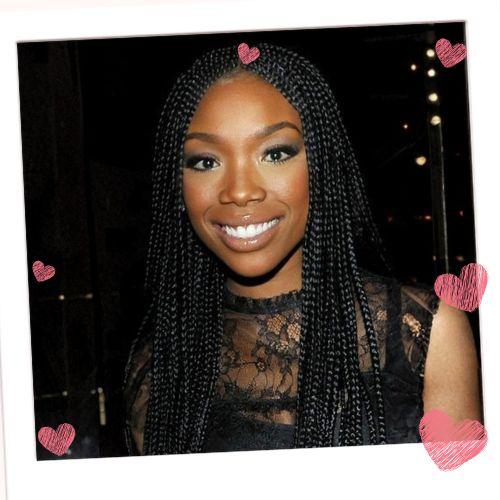 Brandy Norwood with long dark box braids styled in a clean center part flowing past her shoulders
