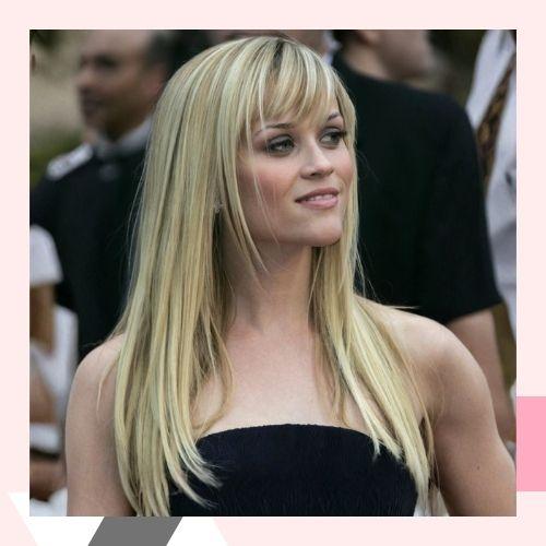 Reese Witherspoon styled in long pin-straight blonde hair with wispy bangs
