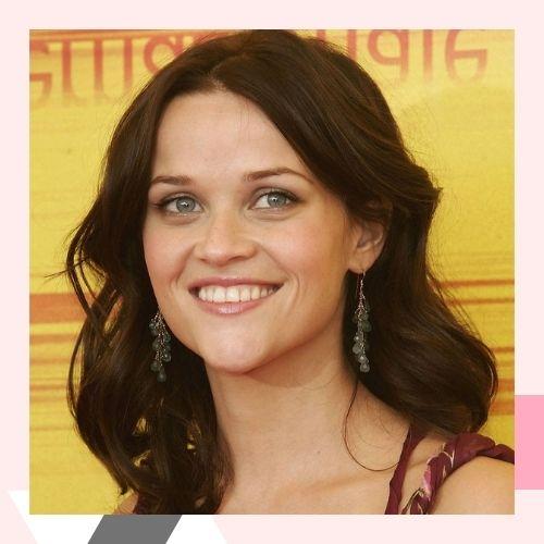 Reese Witherspoon with medium-length dark brown wavy hair on the red carpet