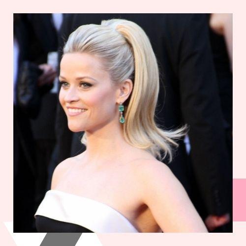 Reese Witherspoon showcasing a sleek platinum blonde high ponytail hairstyle
