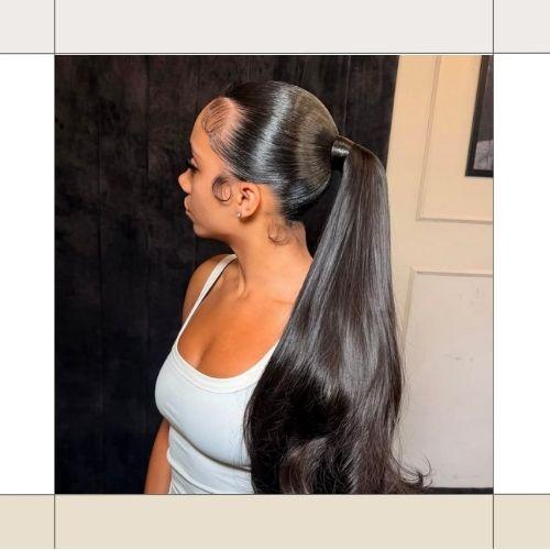 Side view of a woman with long sleek low ponytail hair and slicked edges