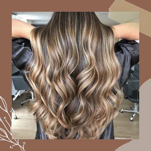 Back view of long wavy brown hair with golden blonde ribbon highlights