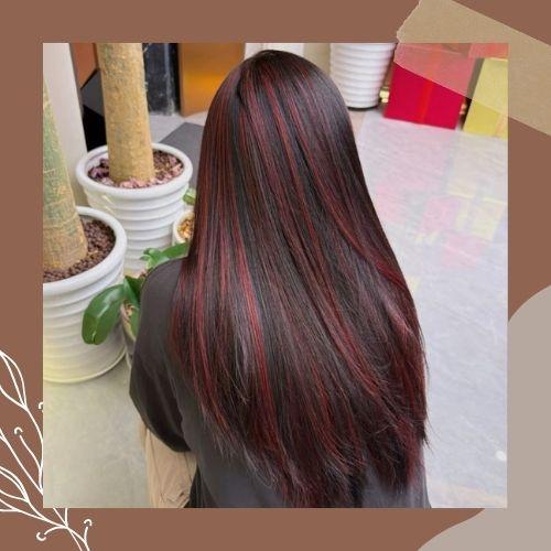 Straight dark brown hair with burgundy red ribbon highlights back view