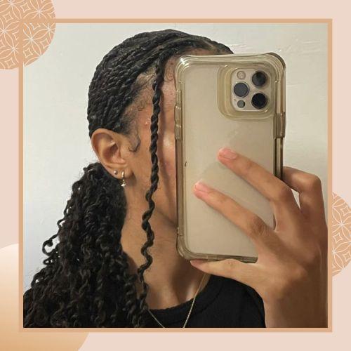 Low ponytail twisted braid hairstyle with wavy curly ends