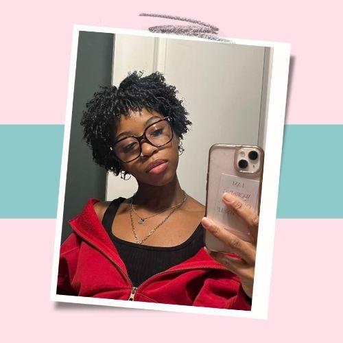 Woman taking a selfie with defined finger-coils hairstyle on short 4C hair