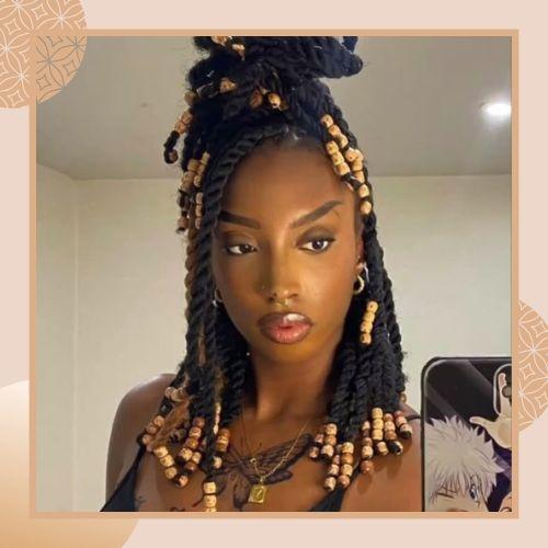 Twist braid hairstyle decorated with golden hair cuffs and beads