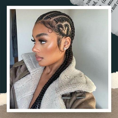 A woman wearing a fleece jacket showing a heart-shaped cornrow braid design on the side of her head.