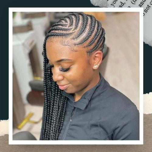 A woman wearing a black collared shirt with side-parted cornrows flowing to one side.