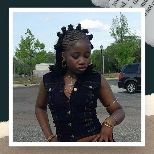 A woman in a black vest featuring cornrow braids combined with Bantu knots on top.