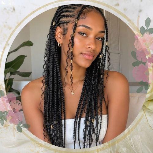 Long box braids wedding hairstyle for black hair with decorative golden cuffs