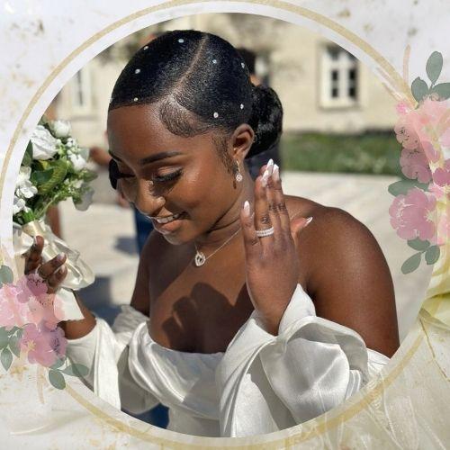 Sleek low bun wedding hairstyle for black hair decorated with delicate rhinestones