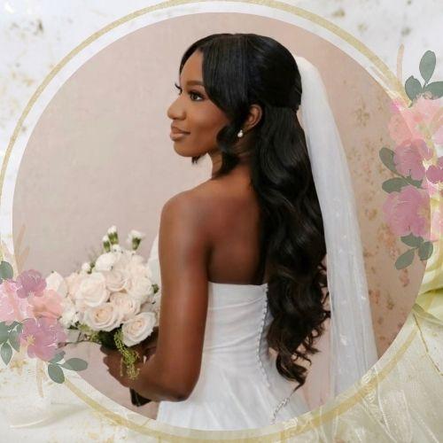 Half up half down curly wedding hairstyle for black women with flowing bridal veil