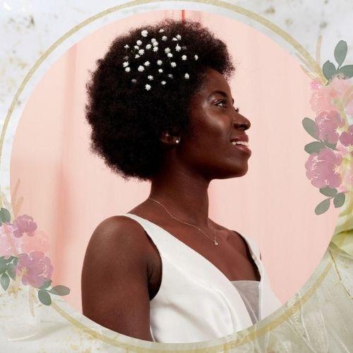Natural afro wedding hairstyle for black women decorated with elegant pearl pins