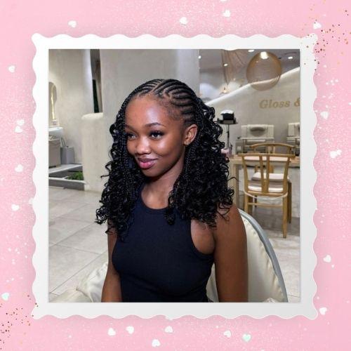 A woman smiling with sleek black fulani boho bob braids in a sleeveless top.