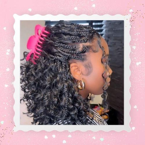 Side profile of a woman with a half-up half-down boho bob braid style clipped with a pink accessory.