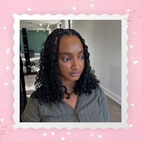 A woman with thick, jumbo boho bob braids posing indoors.