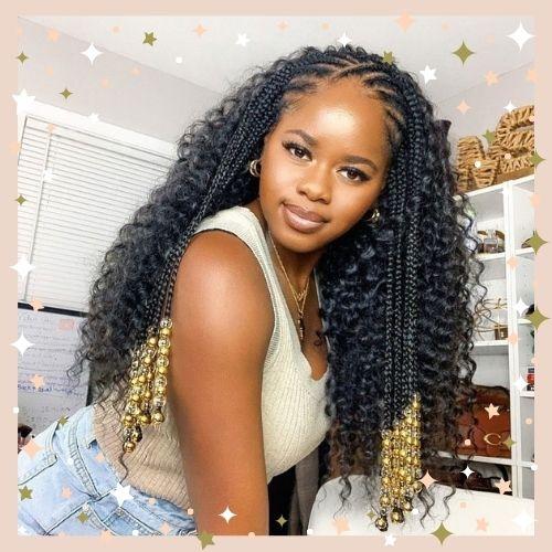 Half braids half sew-in hairstyle featuring golden beads and voluminous curls