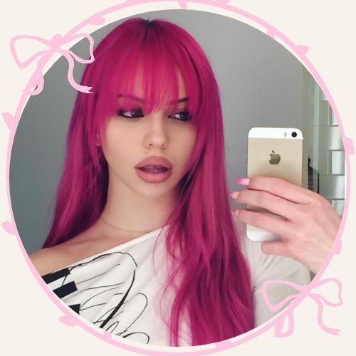 Adela Jergova with bright neon pink hair and full fringe bangs