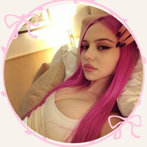 dela Jergova with vibrant neon pink long straight hair