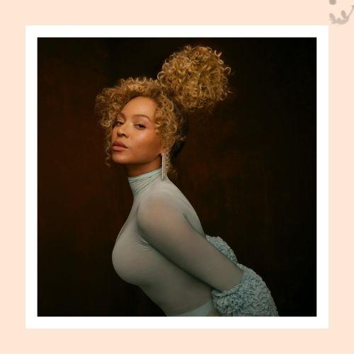 Beyoncé with a high curly pineapple updo hairstyle wearing a light blue turtleneck