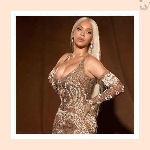 Beyoncé with sleek long blonde straight hair in an elegant shimmering gown
