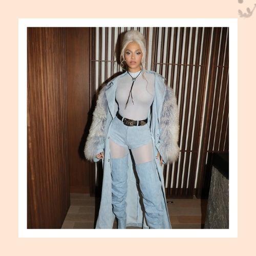Beyoncé styling a platinum blonde beehive updo paired with distressed denim outfit