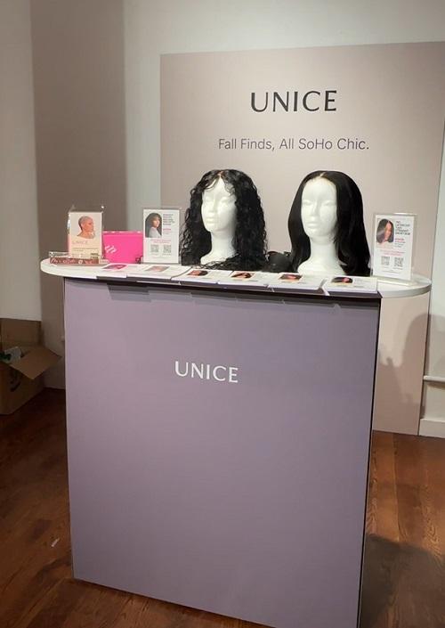 UNice Soho Chic event booth displaying wig products on the table
